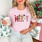 "Merry Christmas Faux Felt Appliqué" graphic on soft pink (blossom) t-shirt.