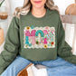 “Mom Patchwork" graphic on muted olive green (military green) sweatshirt.