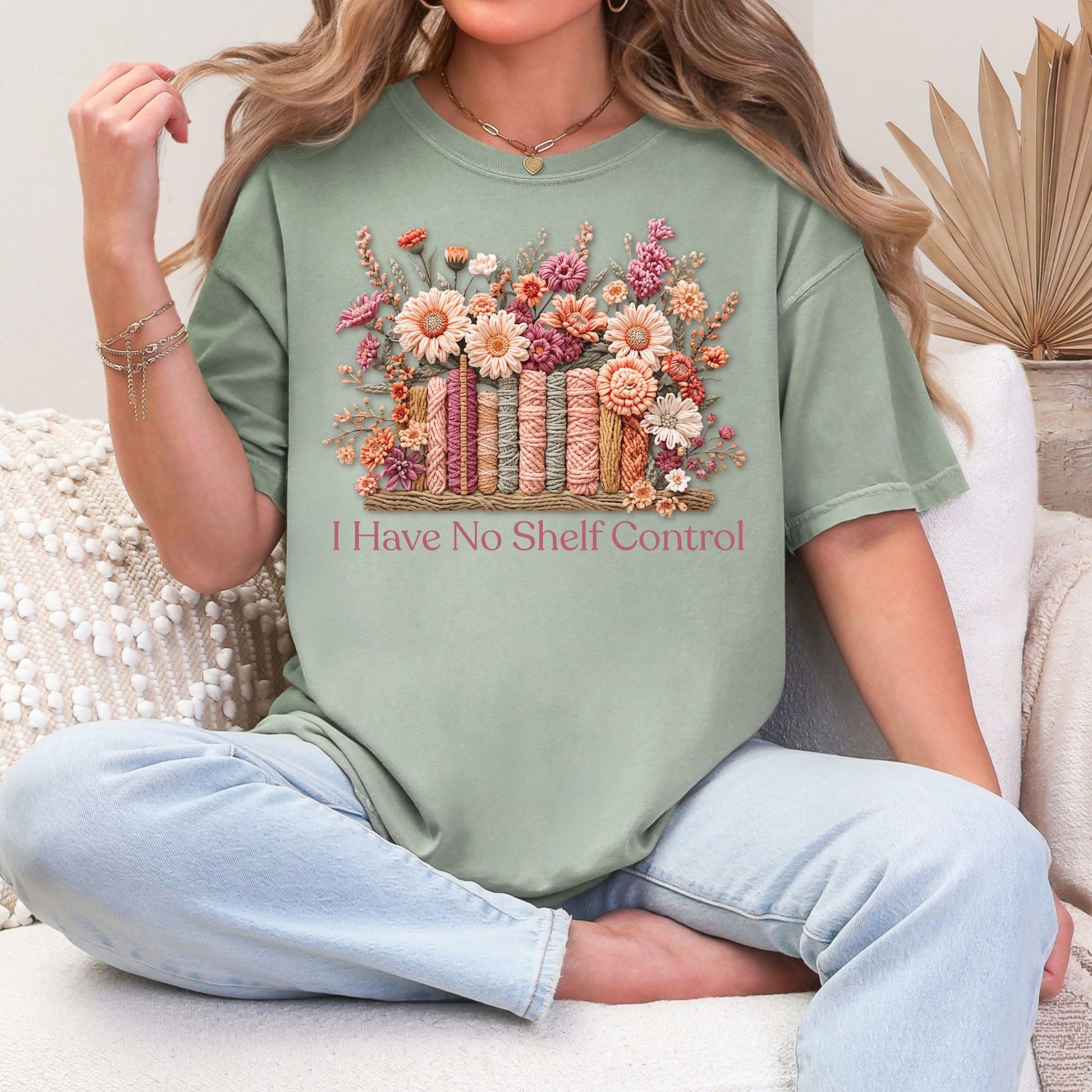 "No Shelf Control" graphic on muted teal-green (bay) t-shirt.