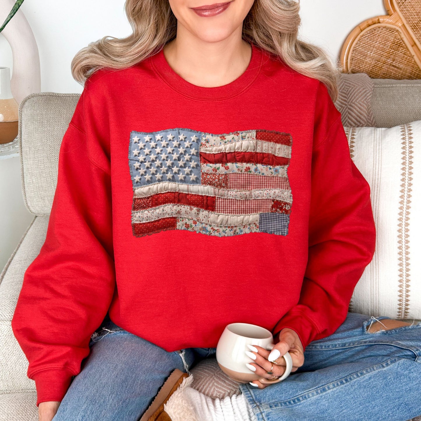Model is wearing a Gildan 18000 T-Shirt in true red (red) featuring a faux patchwork American flag design with stars, stripes, gingham, floral prints, and fabric-style textures.