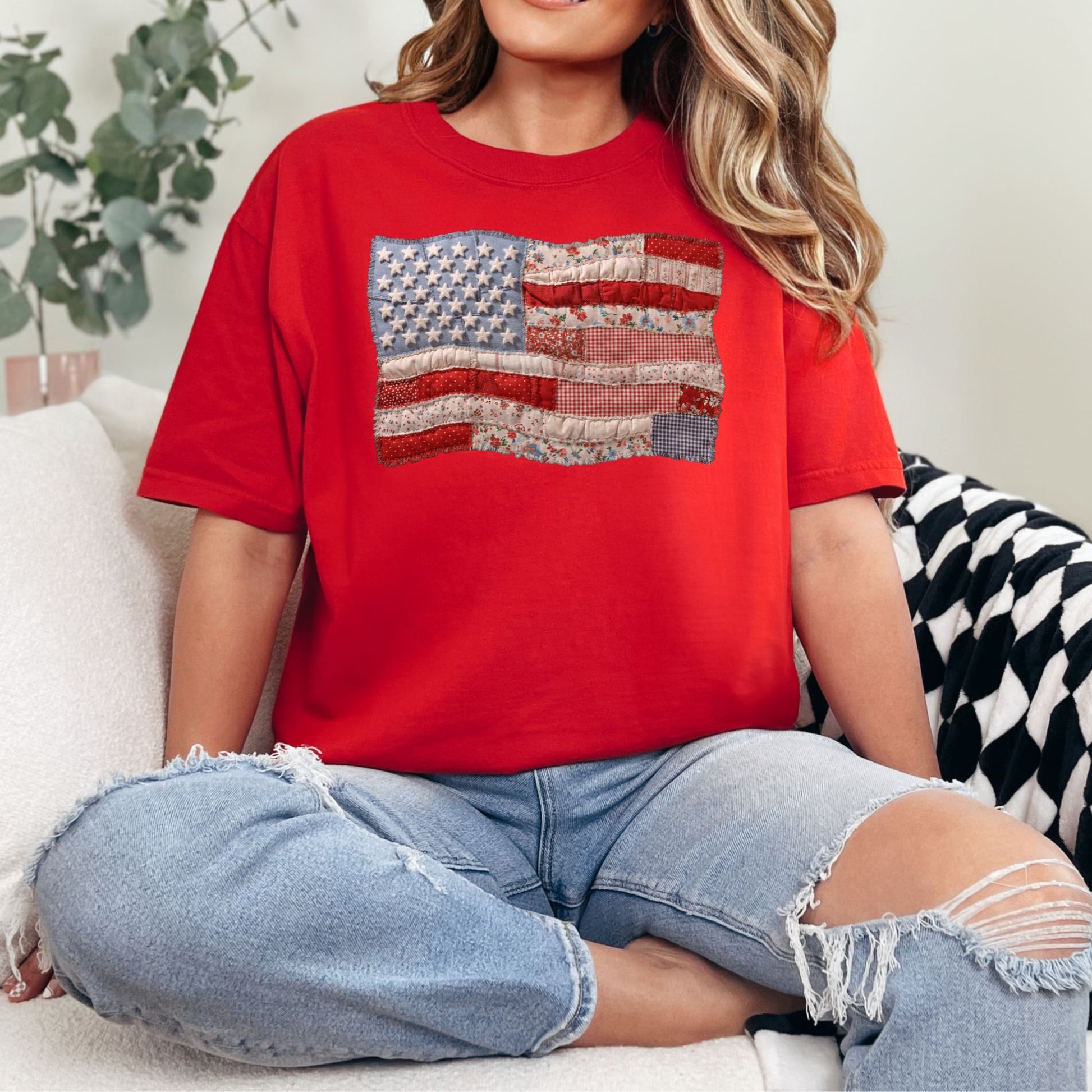 Model is wearing a Comfort Colors 1717 T-Shirt in bright red (red) featuring a faux patchwork American flag design with stars, stripes, gingham, floral prints, and fabric-style textures.