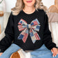 “Patriotic Patchwork Faux Bow" graphic on a black sweatshirt.