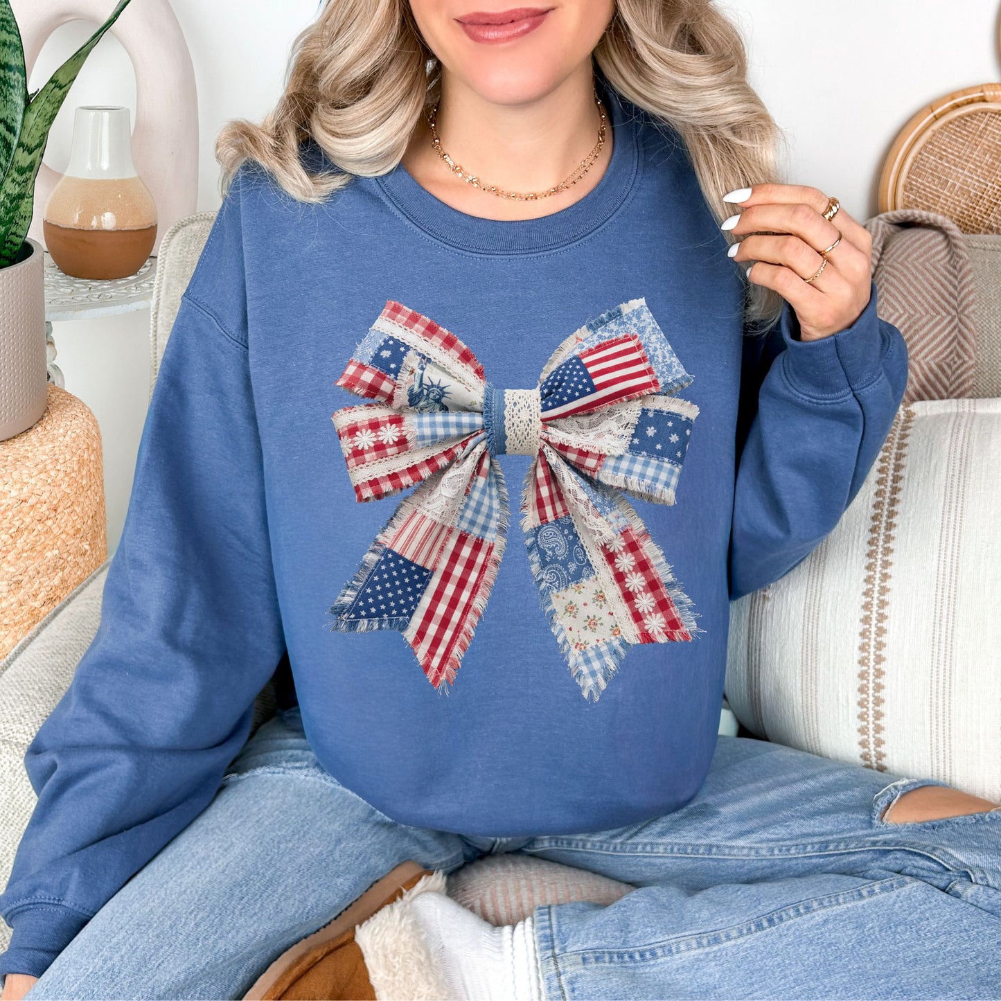 “Patriotic Patchwork Faux Bow" graphic on deep muted blue (indigo blue) sweatshirt.