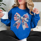 “Patriotic Patchwork Faux Bow" graphic on bright medium blue (royal blue) sweatshirt.