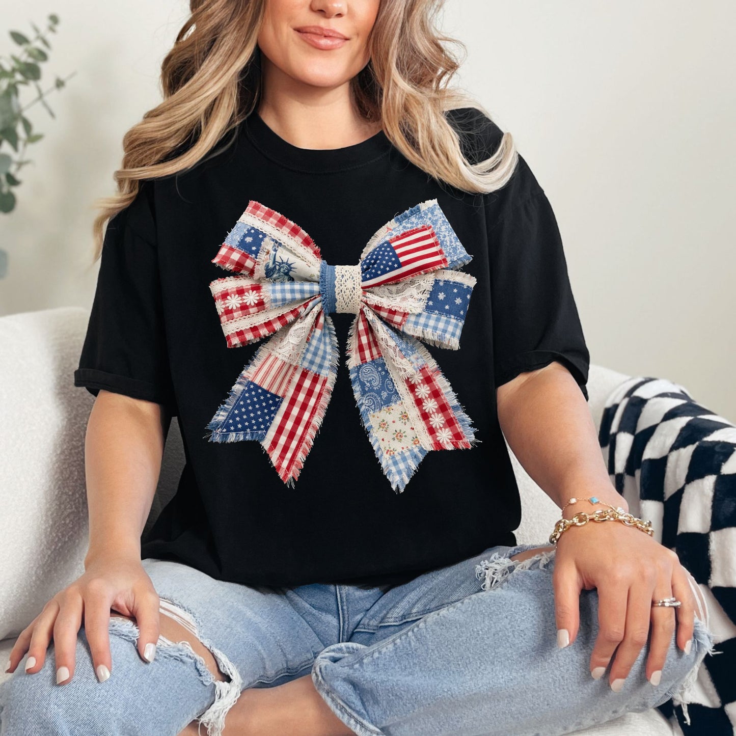 “Patriotic Patchwork Faux Bow" graphic on a black t-shirt.