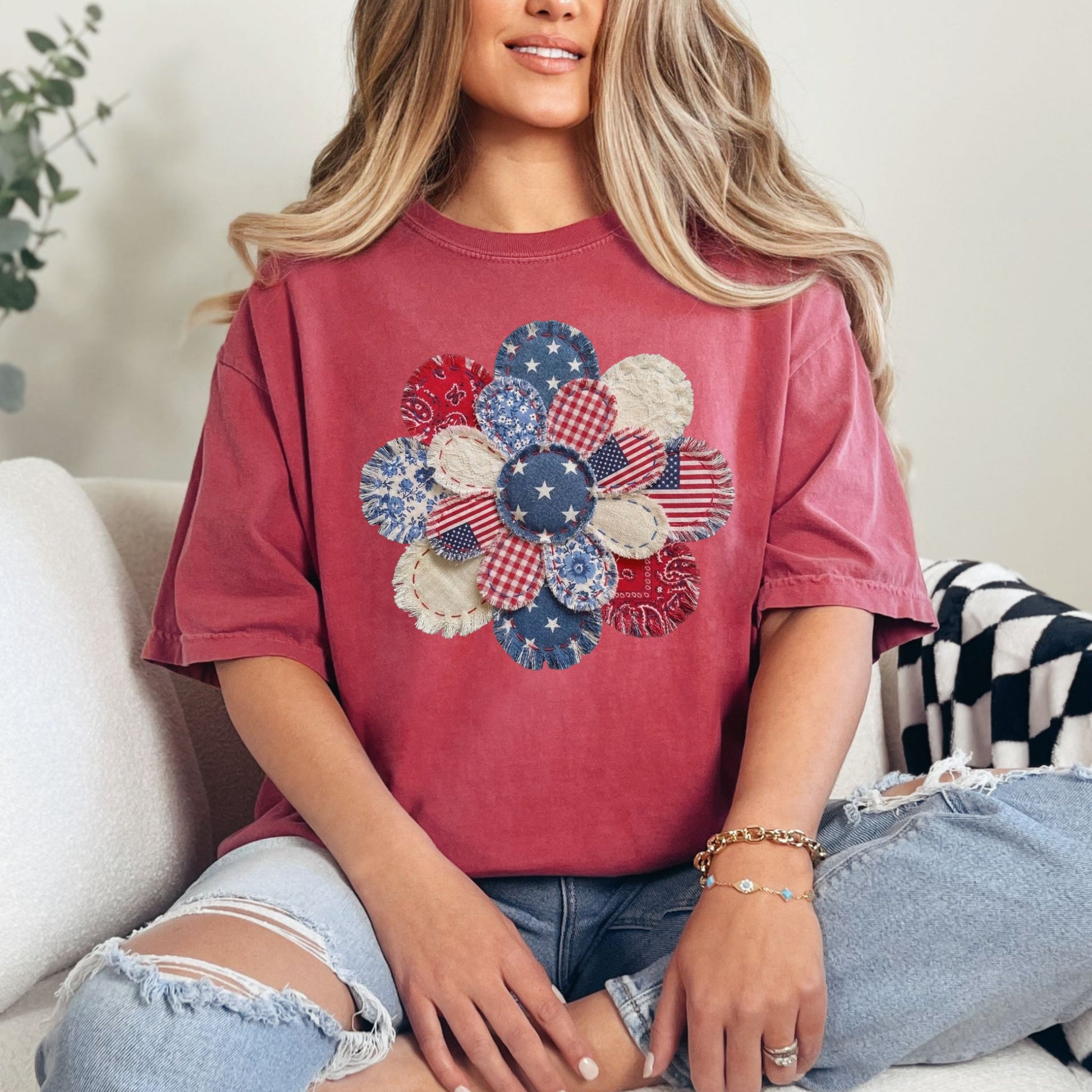 "Patriotic Patchwork Flower" graphic on a deep muted red (crimson) T-Shirt.