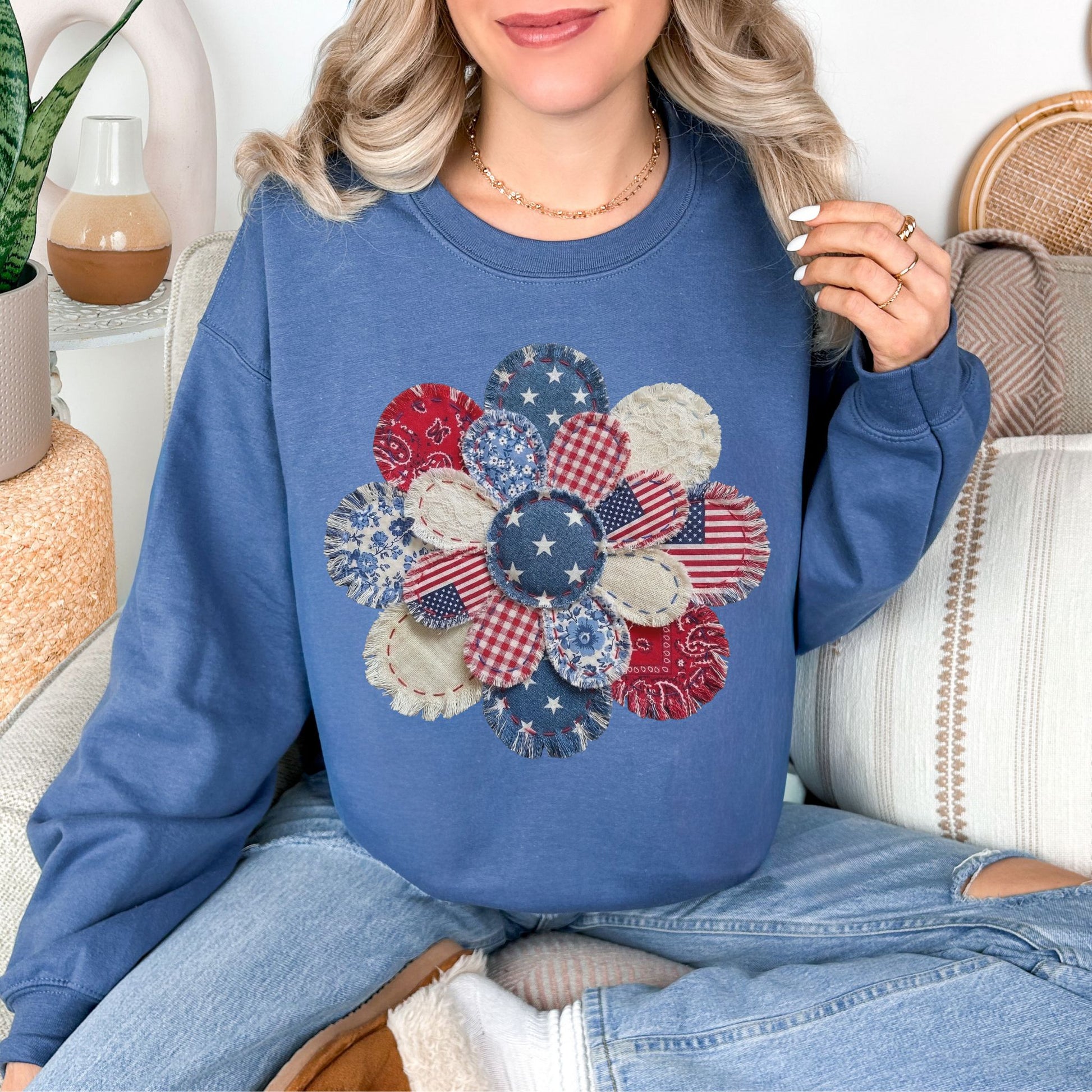 "Patriotic Patchwork Flower" graphic on deep muted blue (indigo blue) sweatshirt.
