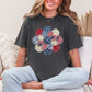 "Patriotic Patchwork Flower" graphic on dark charcoal gray (pepper) T-Shirt.