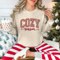"Peppermint Cozy Season Christmas" graphic on light beige (sand) Gildan 18000 sweatshirt.