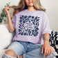 “Puzzling is my therapy" graphic on soft purple (orchid) t-shirt.
