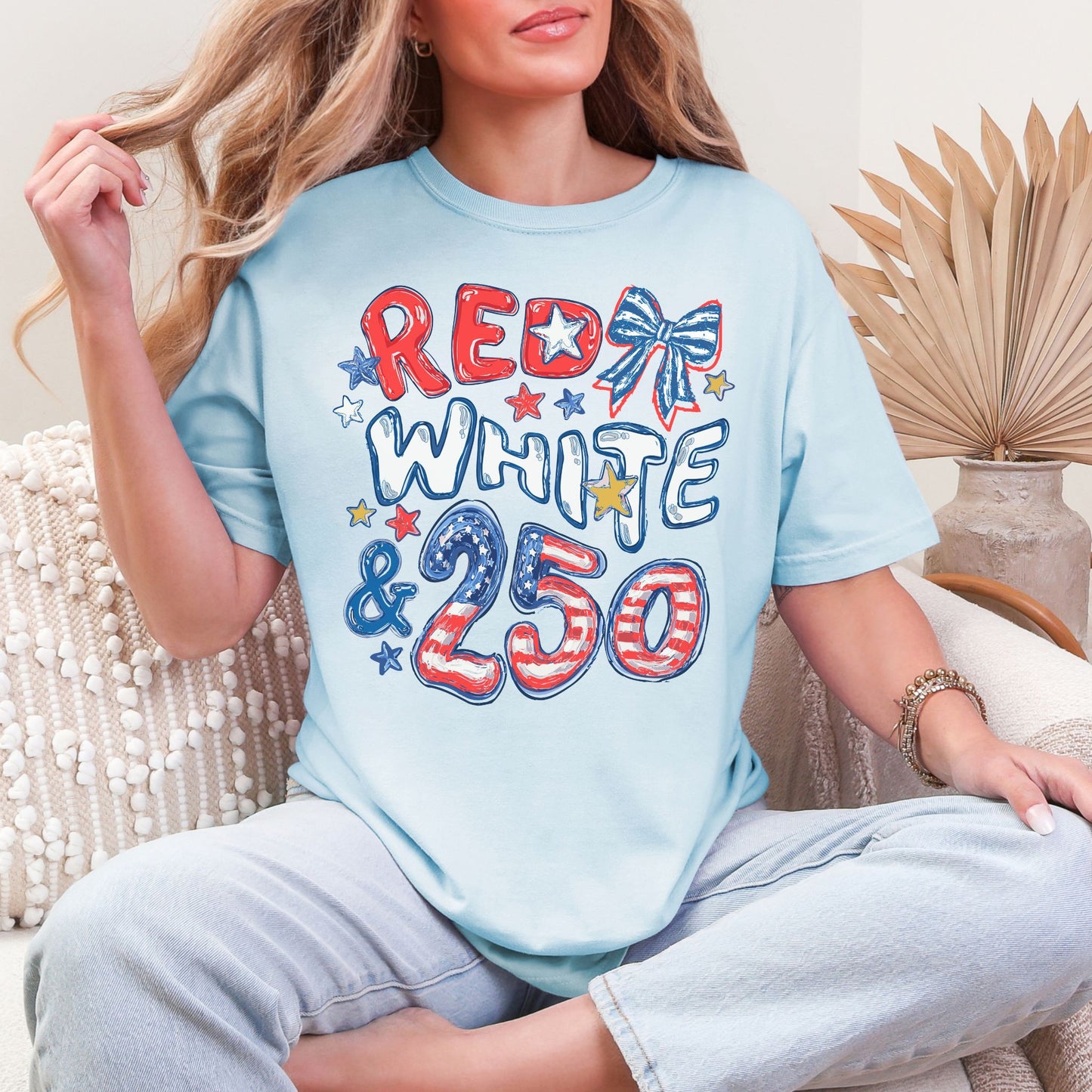 "Red White and 250 Coquette Doodle" graphic on soft medium blue (chambray) T-Shirt.