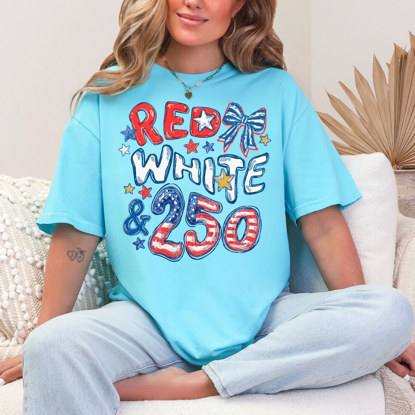 "Red White and 250 Coquette Doodle" graphic on soft medium blue (lagoon blue) T-Shirt.