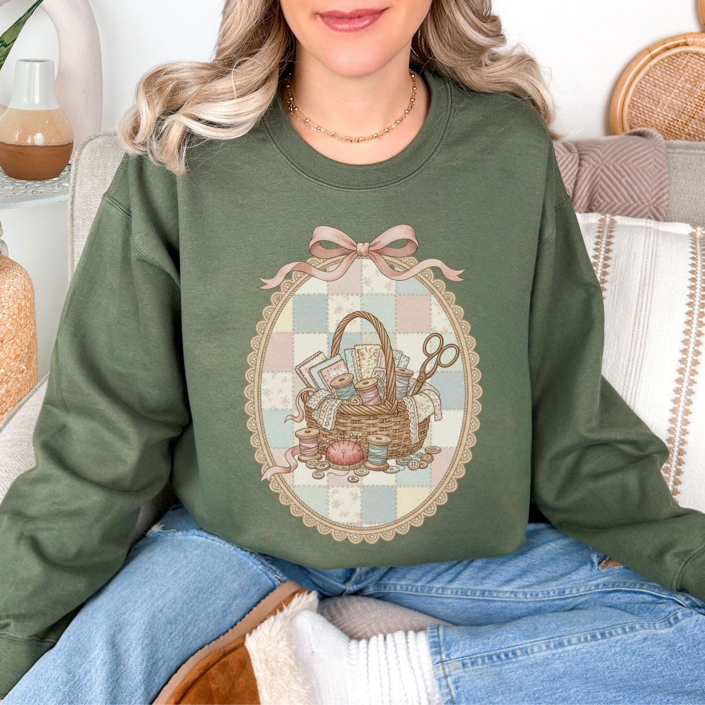"Sewing Basket Vintage Coquette" graphic on muted olive green (military green) Sweatshirt.