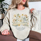 "Sewing she works willingly" graphic on light warm beige (sand) sweatshirt.