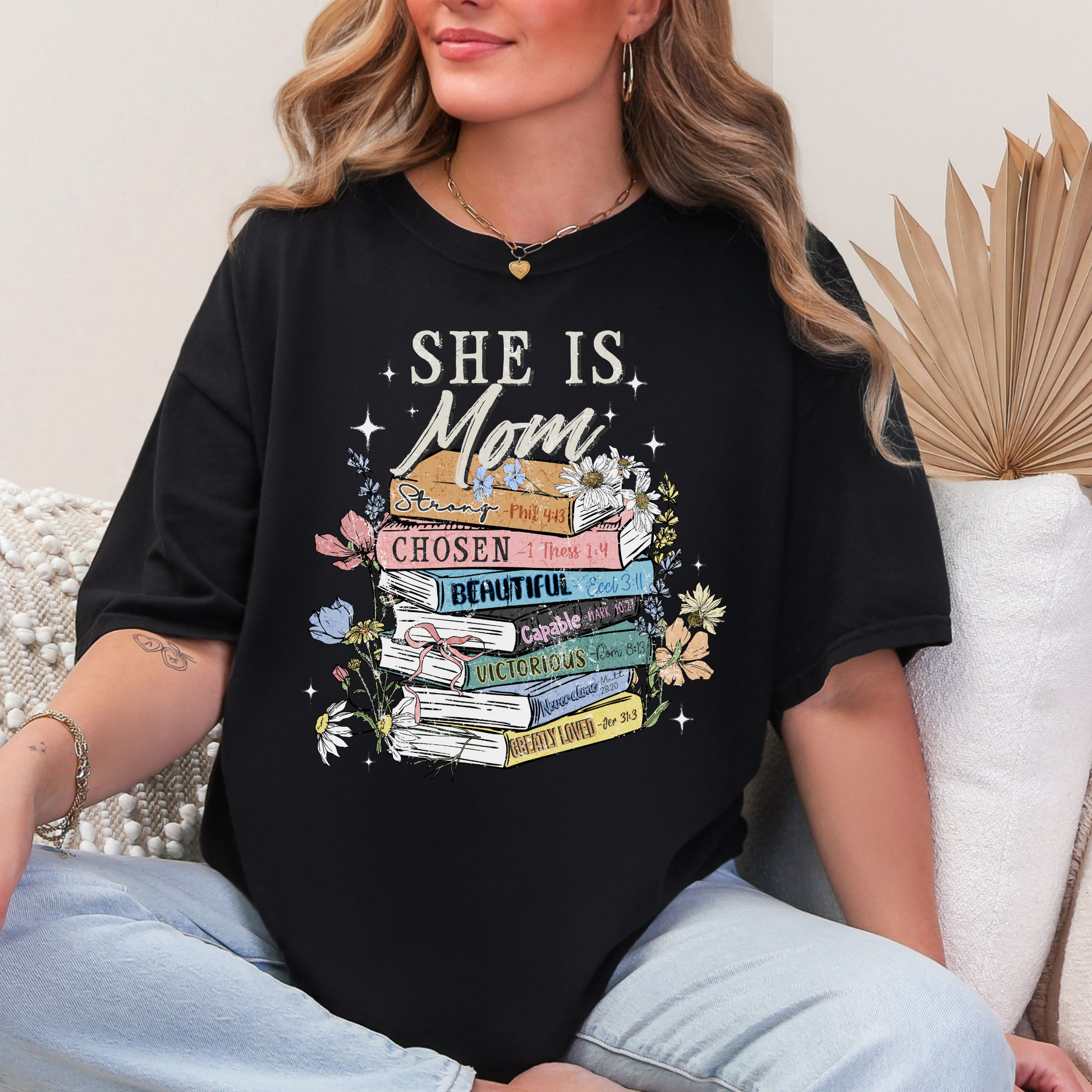 "She is Mom" graphic on a black T-Shirt.