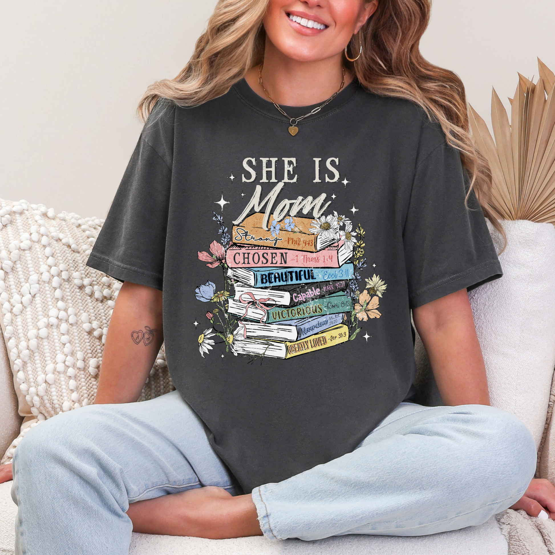 "She is Mom" graphic on dark charcoal gray (pepper) T-Shirt.