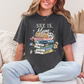 "She is Mom" graphic on dark charcoal gray (pepper) T-Shirt.