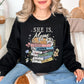 "She is mom" graphic on very black (black) Sweatshirt.
