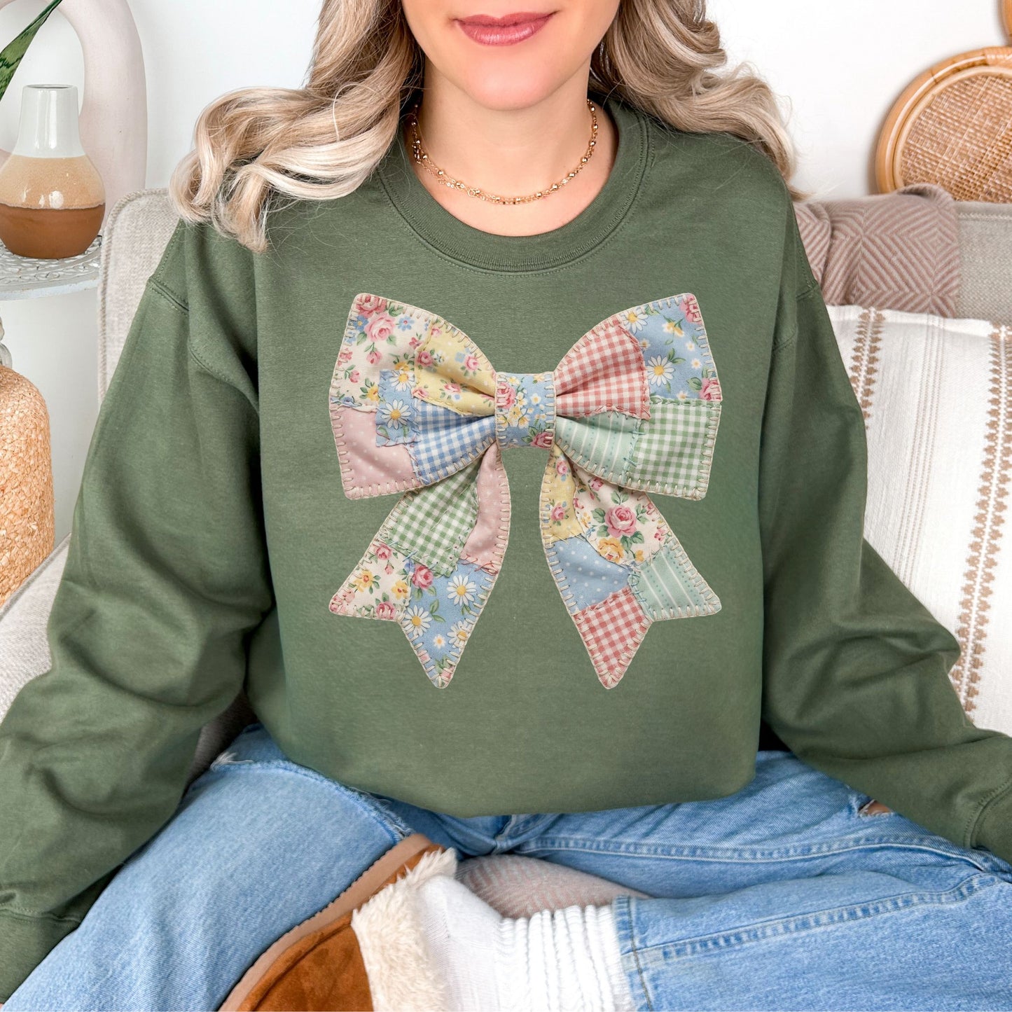 “Spring Faux Patchwork Bow" graphic on muted olive green (military green) sweatshirt.