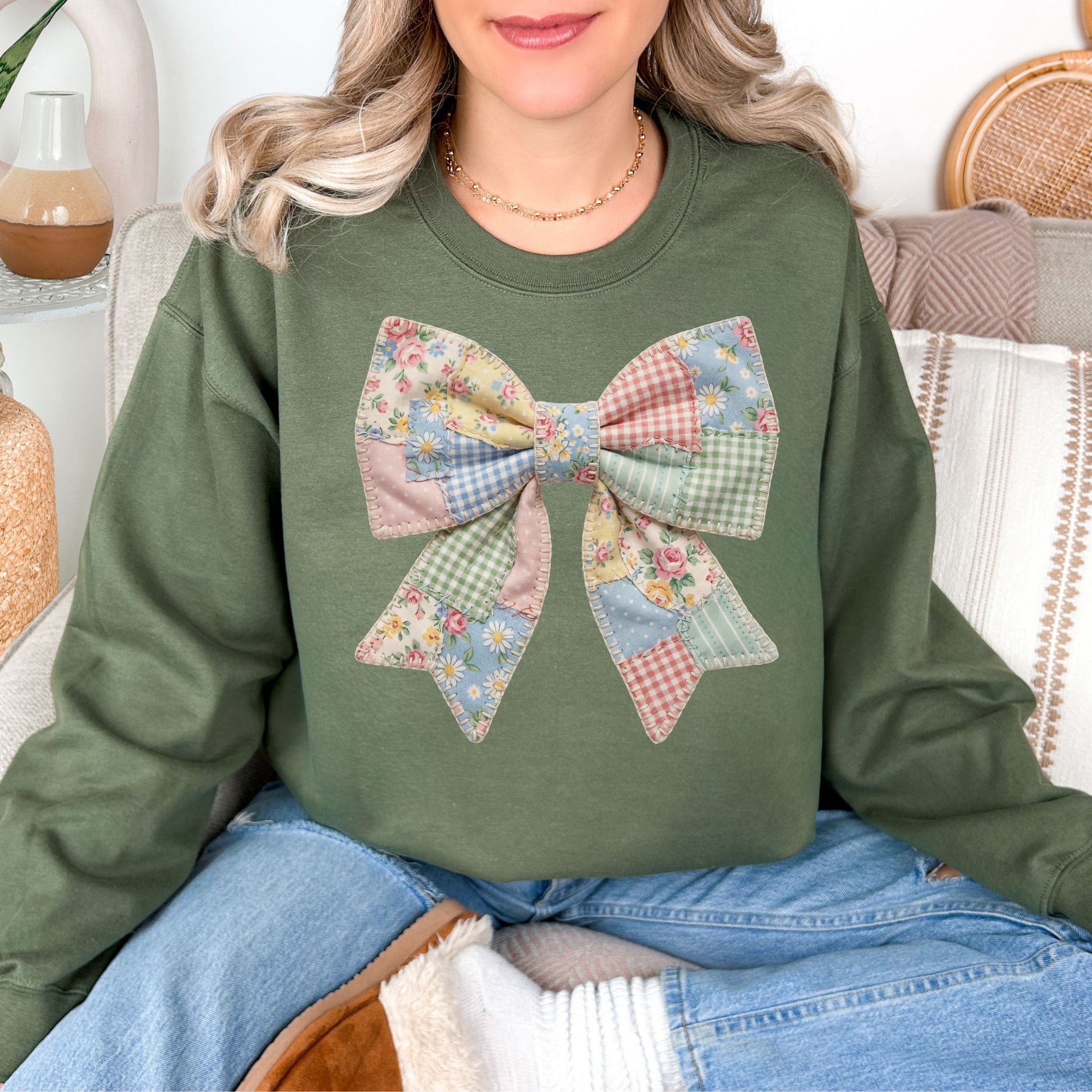 “Spring Faux Patchwork Bow" graphic on muted olive green (military green) sweatshirt.