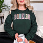 “Spring Floral Bookish Mama" graphic on a dark green (forest green) Sweatshirt.