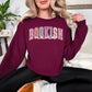 “Spring Floral Bookish Mama" graphic on deep red (maroon) Sweatshirt.