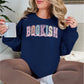 “Spring Floral Bookish Mama" graphic on dark blue (navy) Sweatshirt.