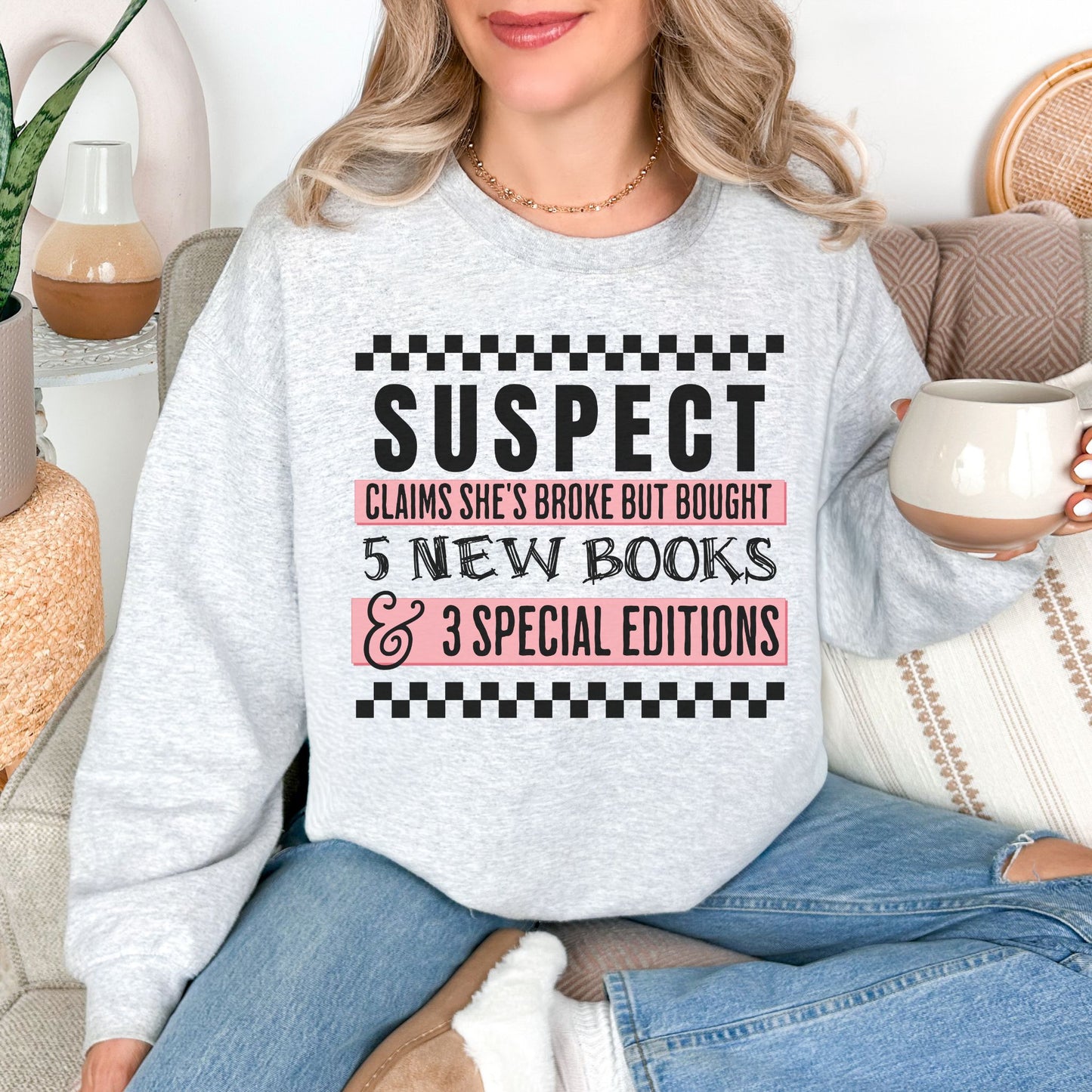 "Suspect Claims She's Broke" graphic on very light gray (ash) Sweatshirt