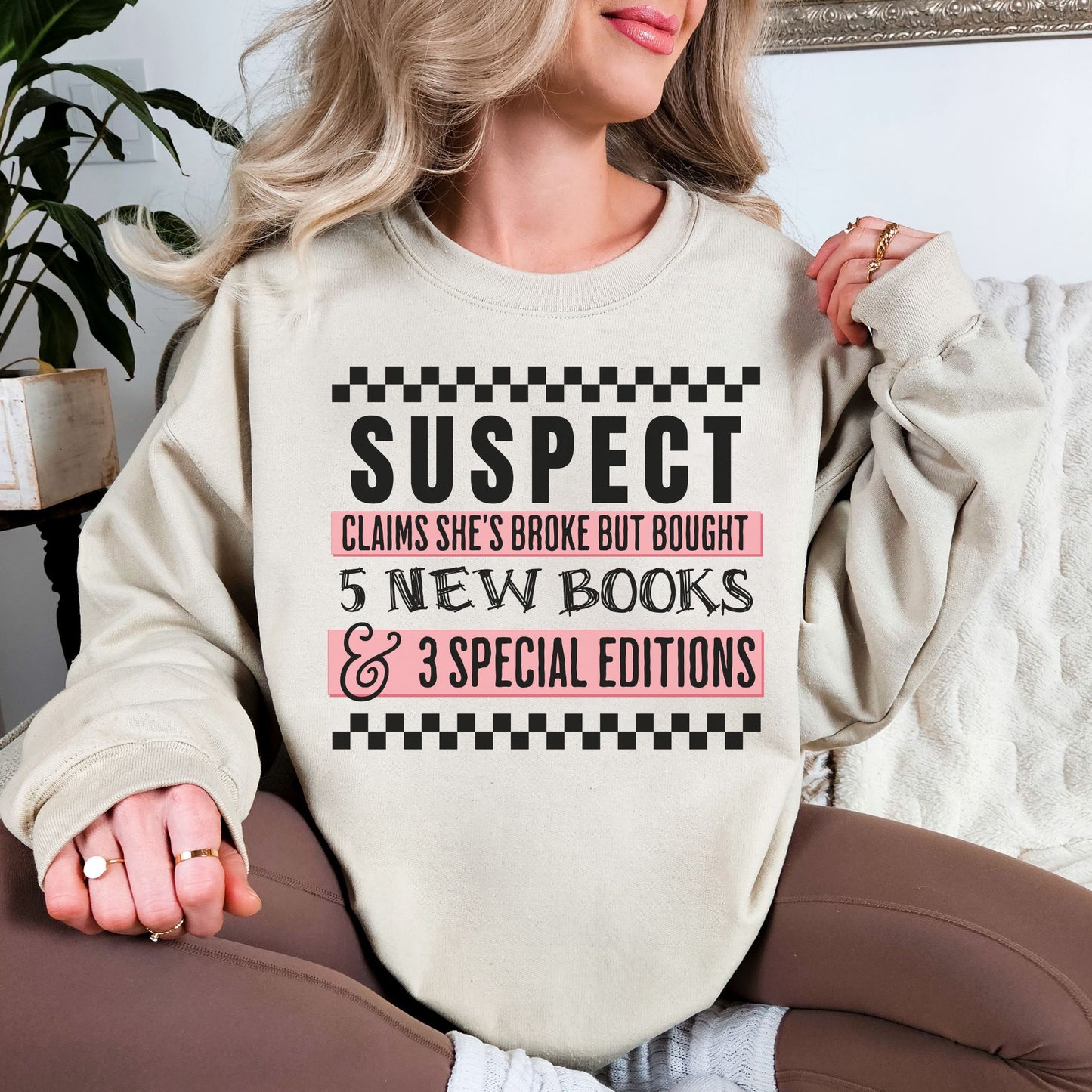 "Suspect Claims She's Broke" graphic on very light gray (ash) Sweatshirt