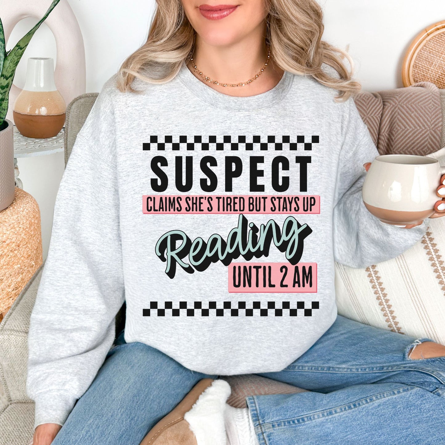 “Suspect claims she's tired" graphic on very light gray (ash) Sweatshirt