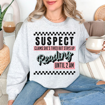 “Suspect claims she's tired" graphic on very light gray (ash) Sweatshirt