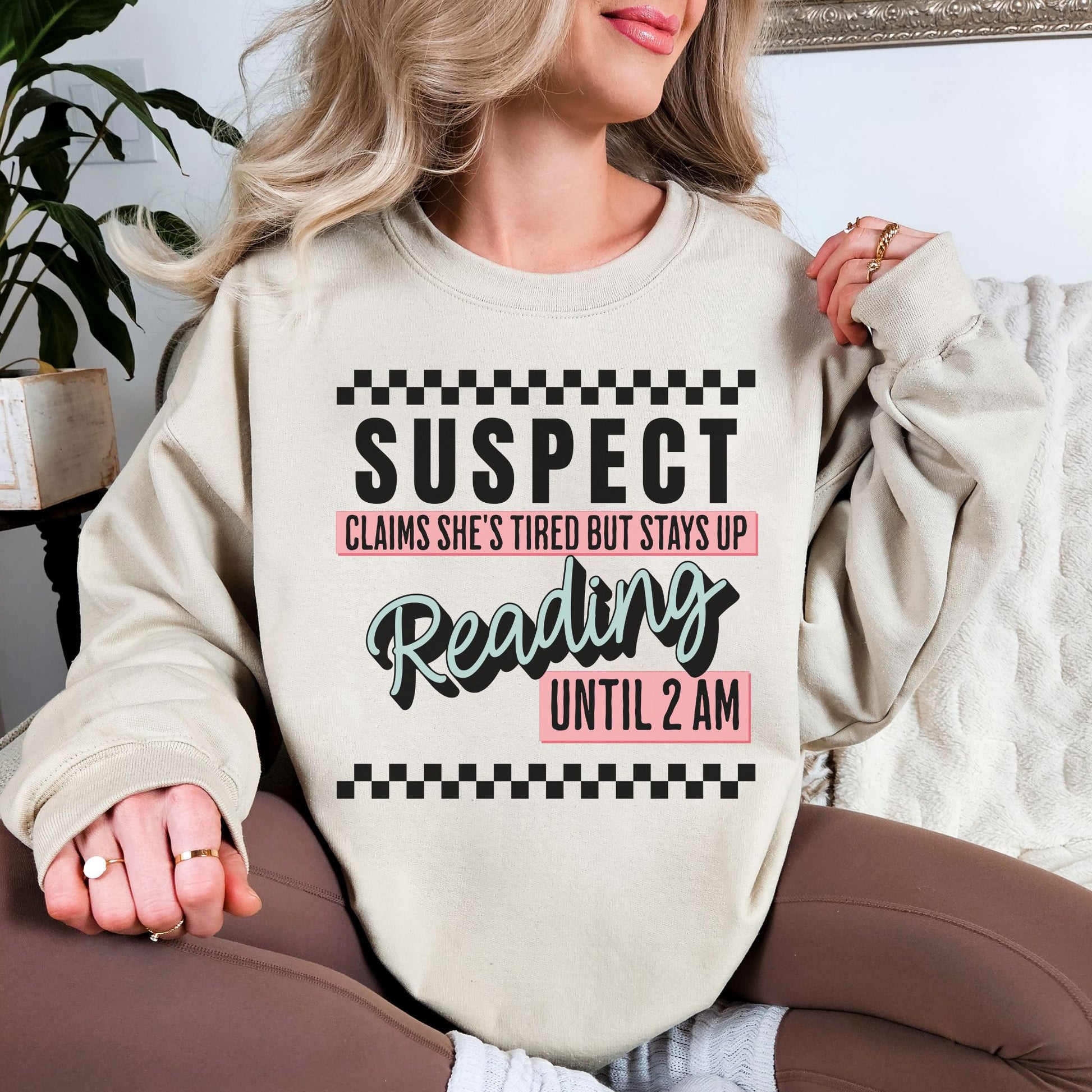 “Suspect claims she's tired" graphic on light warm beige (sand) Sweatshirt