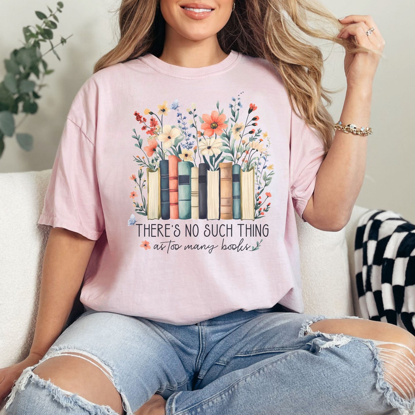 "There's no such thing as too many books" graphic on soft pink (blossom) T-shirt.