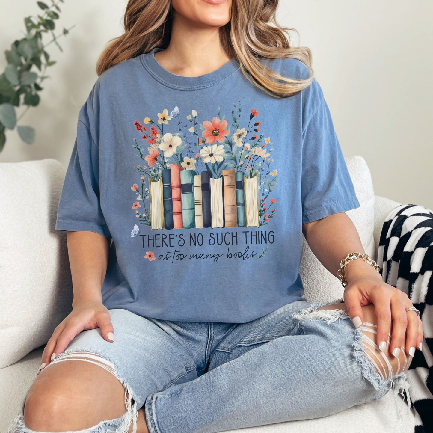 "There's no such thing as too many books" graphic on muted denim blue (blue jean) T-shirt.