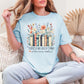 "There's no such thing as too many books" graphic on soft medium blue (chambray) T-shirt.