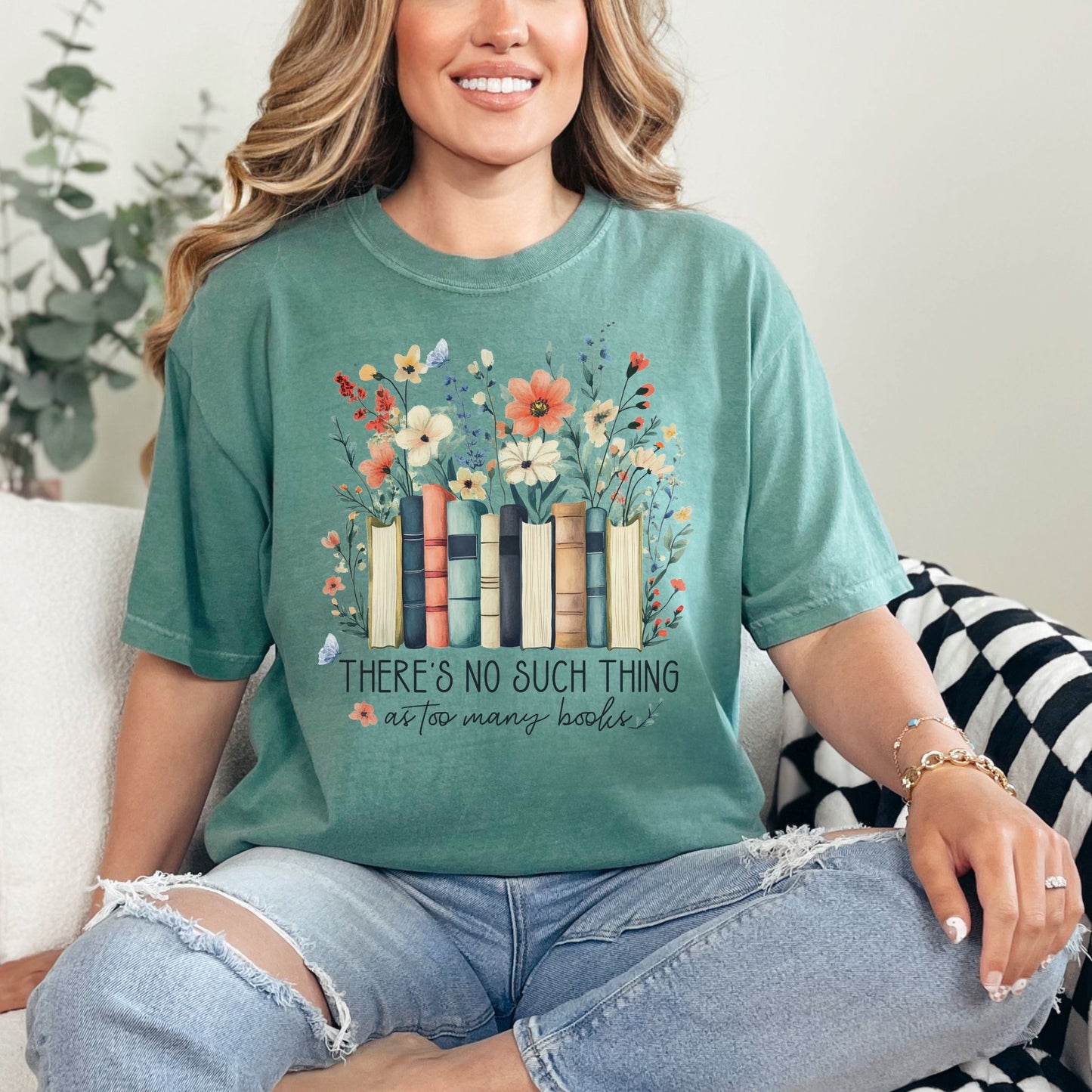"There's no such thing as too many books" graphic on soft light green (light green) T-shirt.