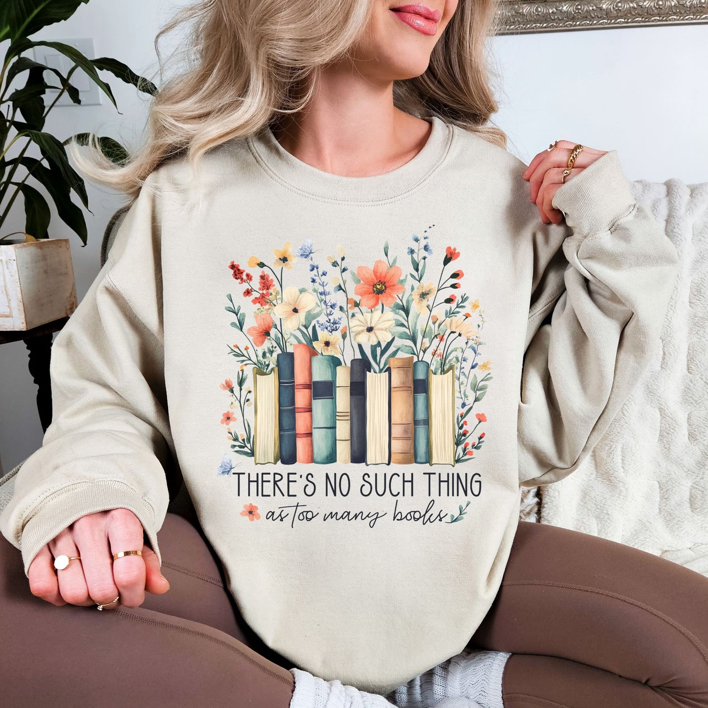 “There's no such thing as too many books" graphic on light warm beige (sand) Sweatshirt