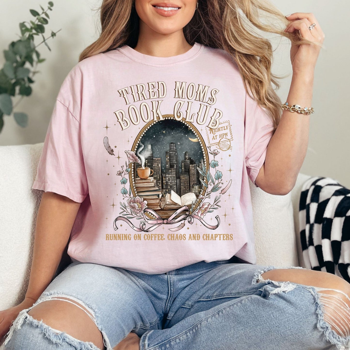 "Tired Moms Book Club" graphic on soft pink (blossom) t-shirt.