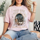 "Tired Moms Book Club" graphic on soft pink (blossom) t-shirt.