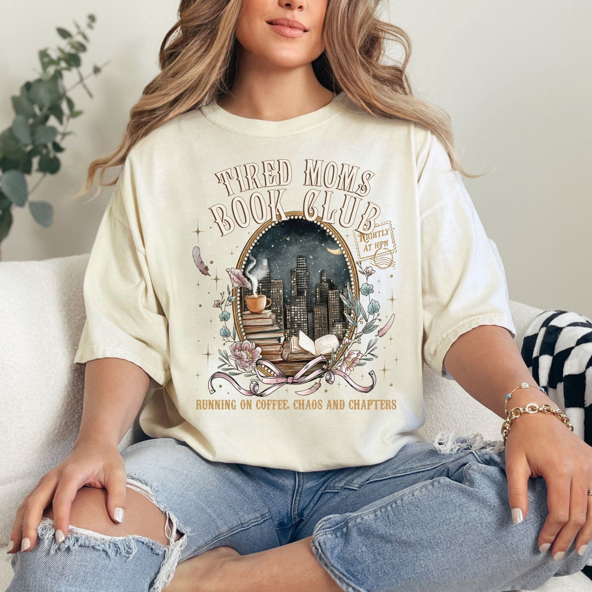 "Tired Moms Book Club" graphic on soft off-white (ivory) t-shirt.