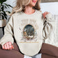 "Tired Moms Book Club" graphic on light warm beige (sand) sweatshirt