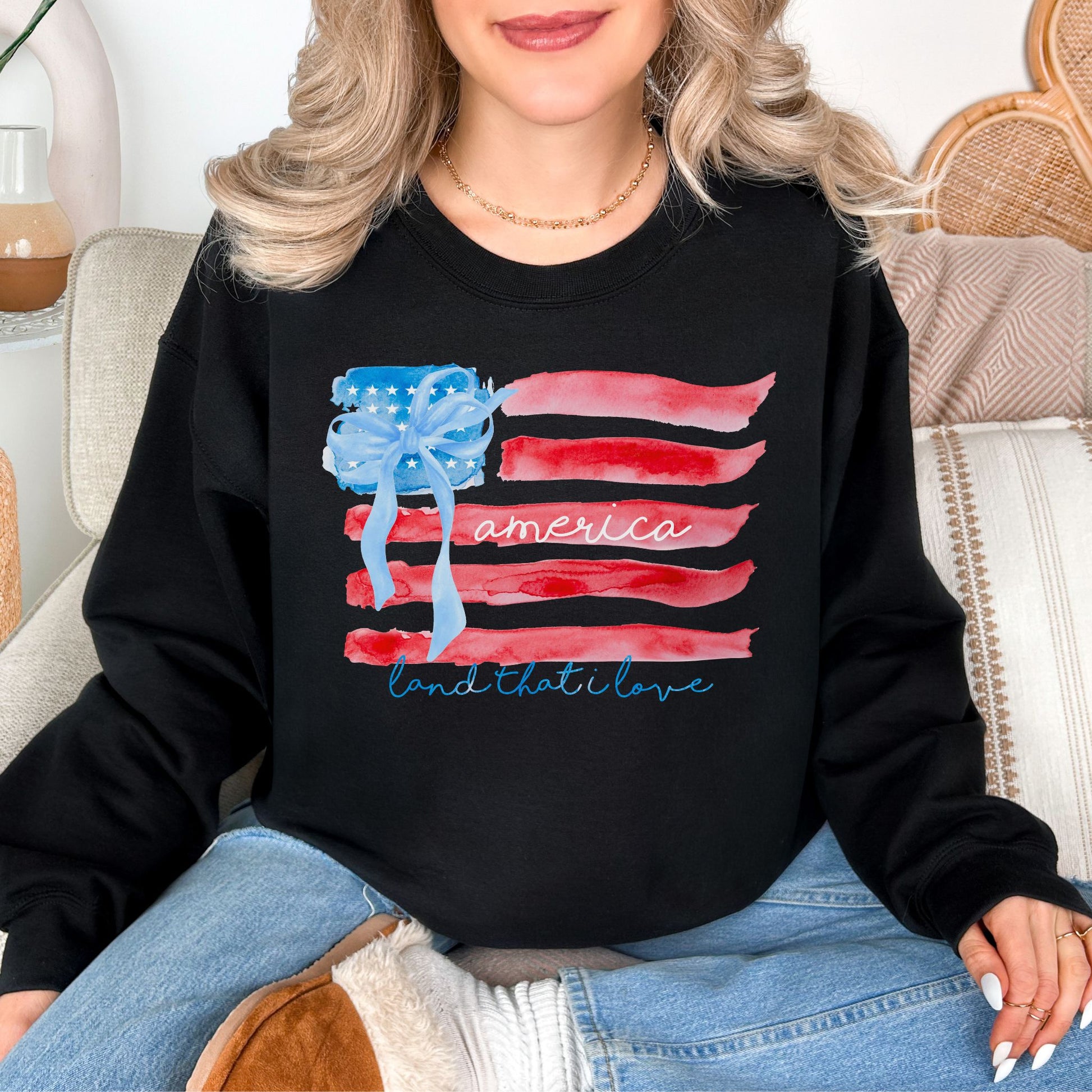 "Coquette Watercolor American Flag" graphic on a true black (black) Sweatshirt.