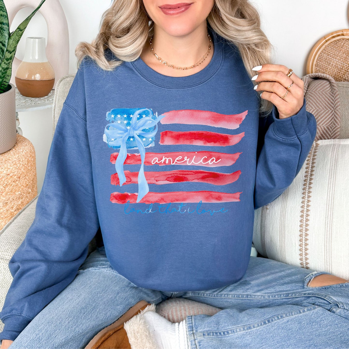 "Coquette Watercolor American Flag" graphic on a deep muted blue (indigo blue) Sweatshirt.
