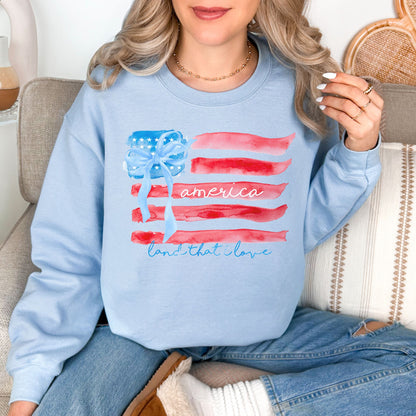 "Coquette Watercolor American Flag" graphic on pale blue (light blue) Sweatshirt.