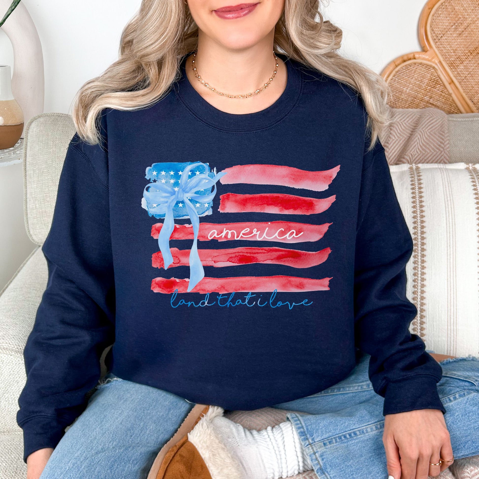 "Coquette Watercolor American Flag" graphic on dark blue (navy) Sweatshirt.