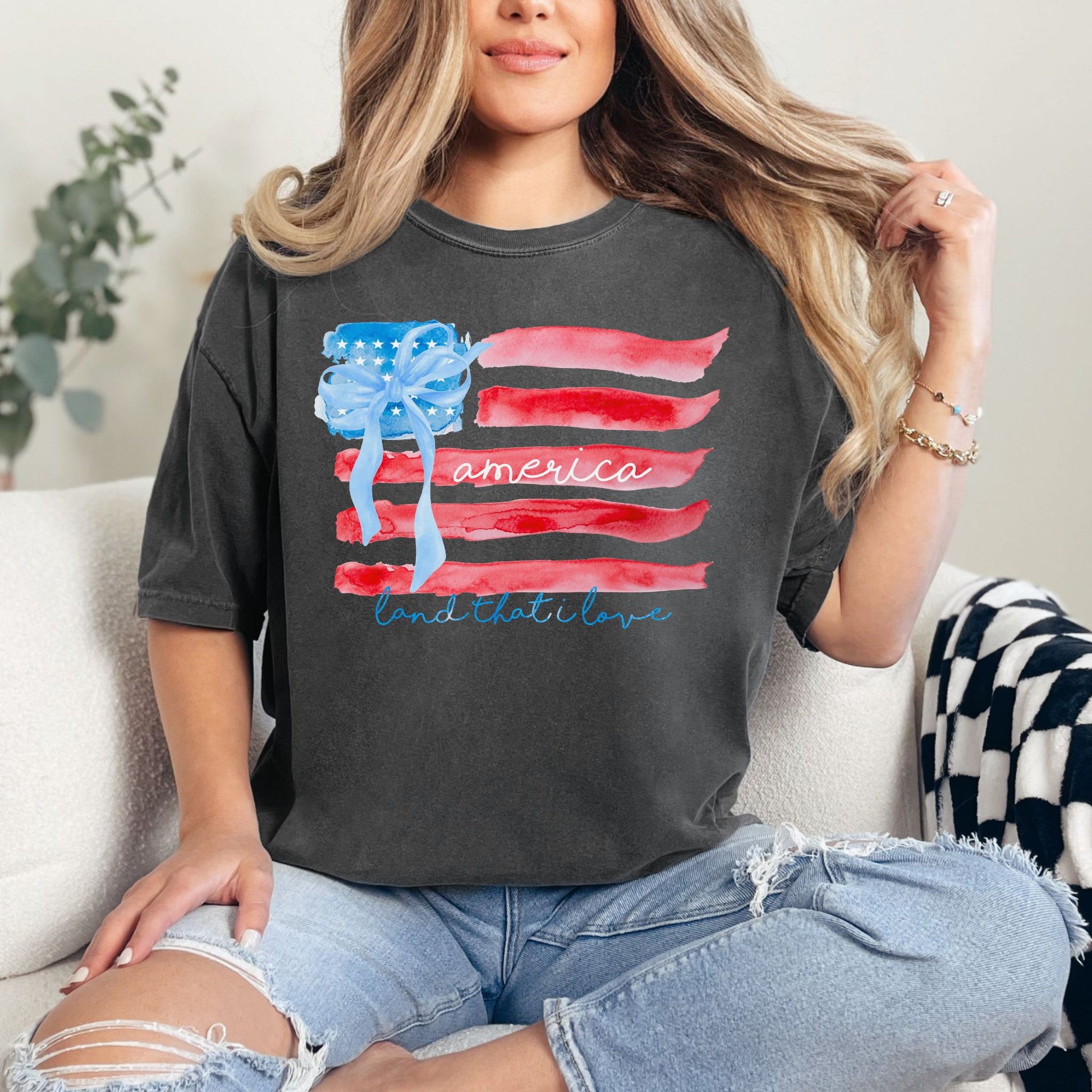 "Coquette Watercolor American Flag" graphic on dark charcoal gray (pepper) T-shirt.