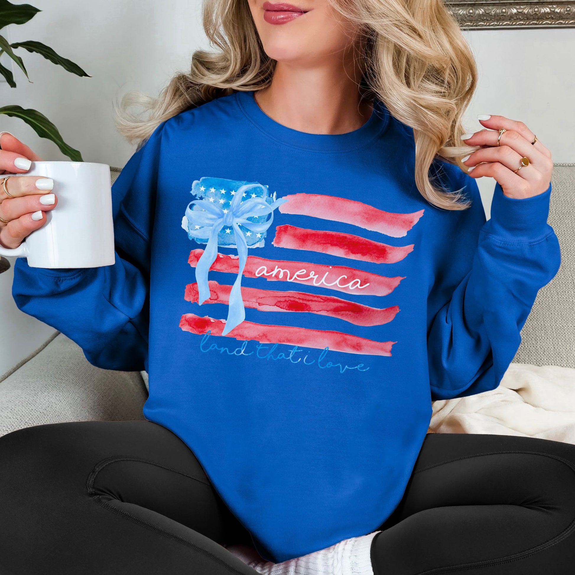 "Coquette Watercolor American Flag" graphic on a bright medium blue (royal blue) Sweatshirt.