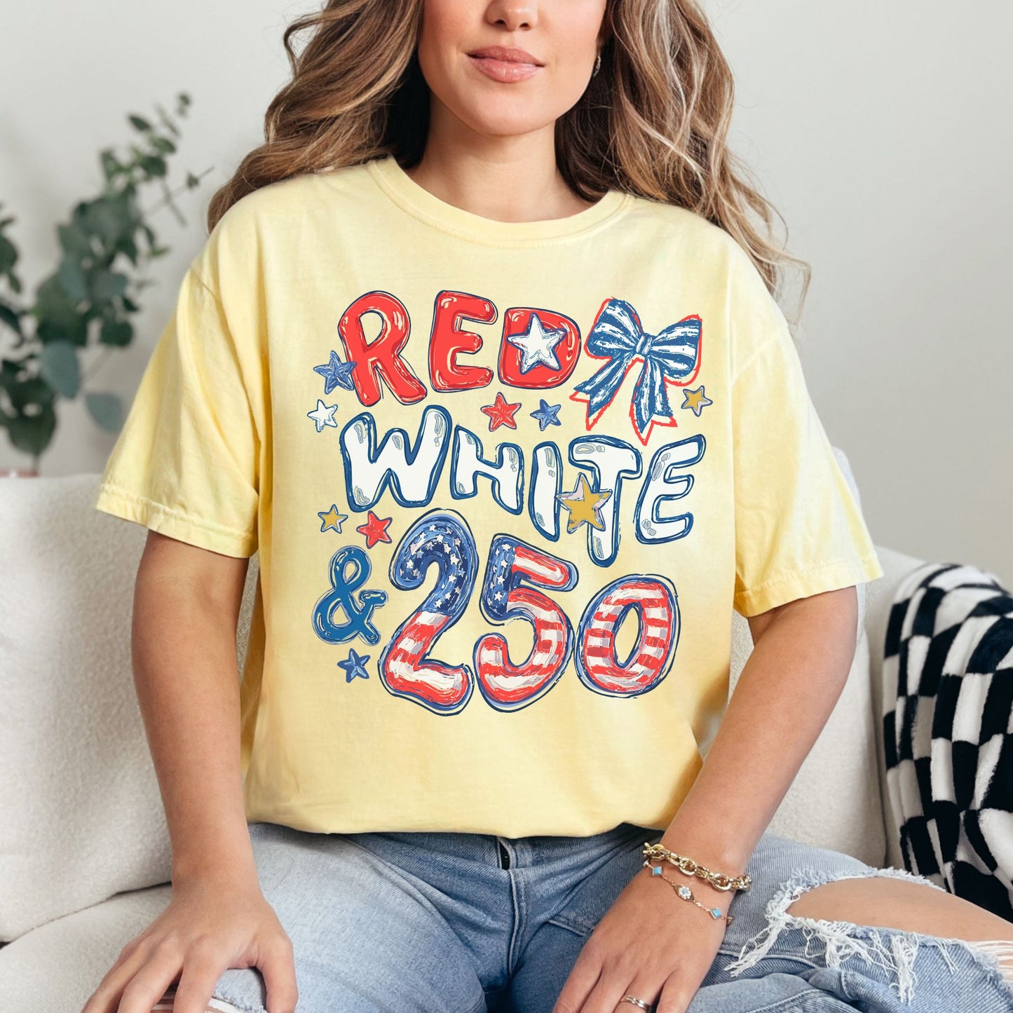 "Red White and 250 Coquette Doodle" graphic on soft yellow (butter) T-Shirt.