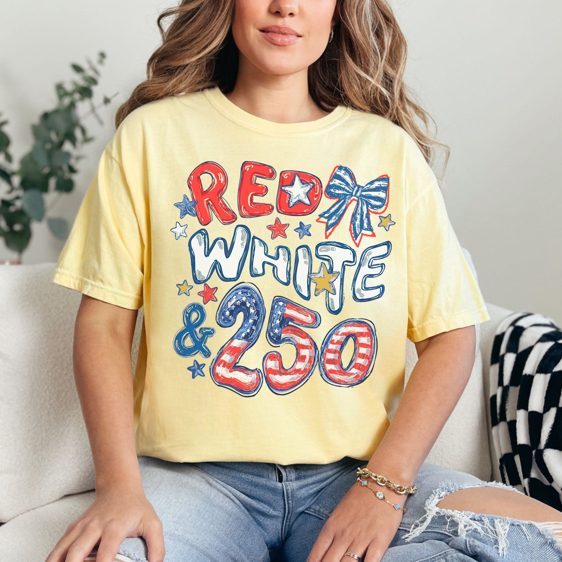 "Red White and 250 Coquette Doodle" graphic on soft yellow (butter) T-Shirt.